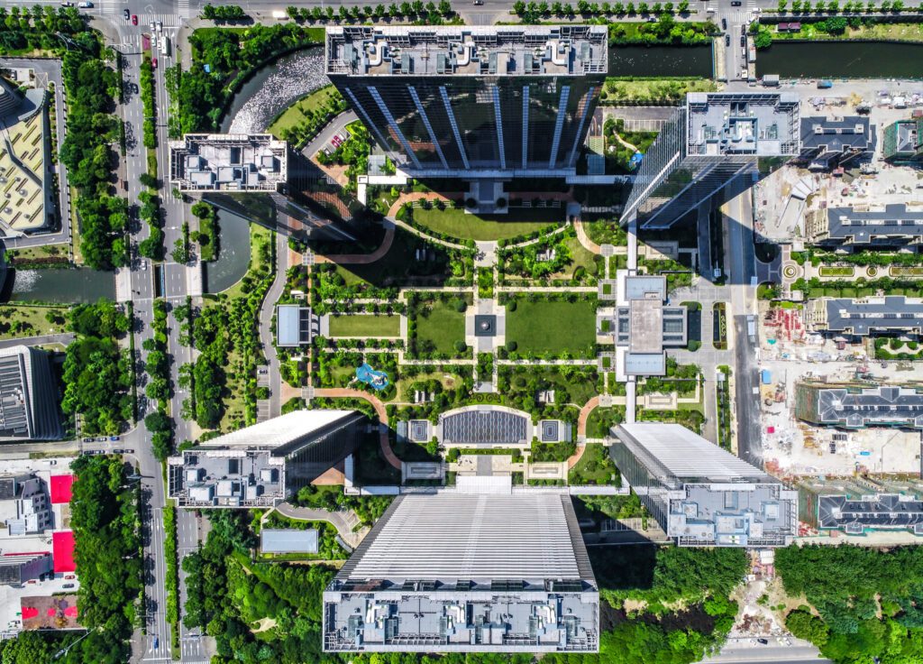 Wide aerial view of cutting-edge tech campus architecture that shifts local market dynamics and complicates national housing market predictions regarding home inventory.