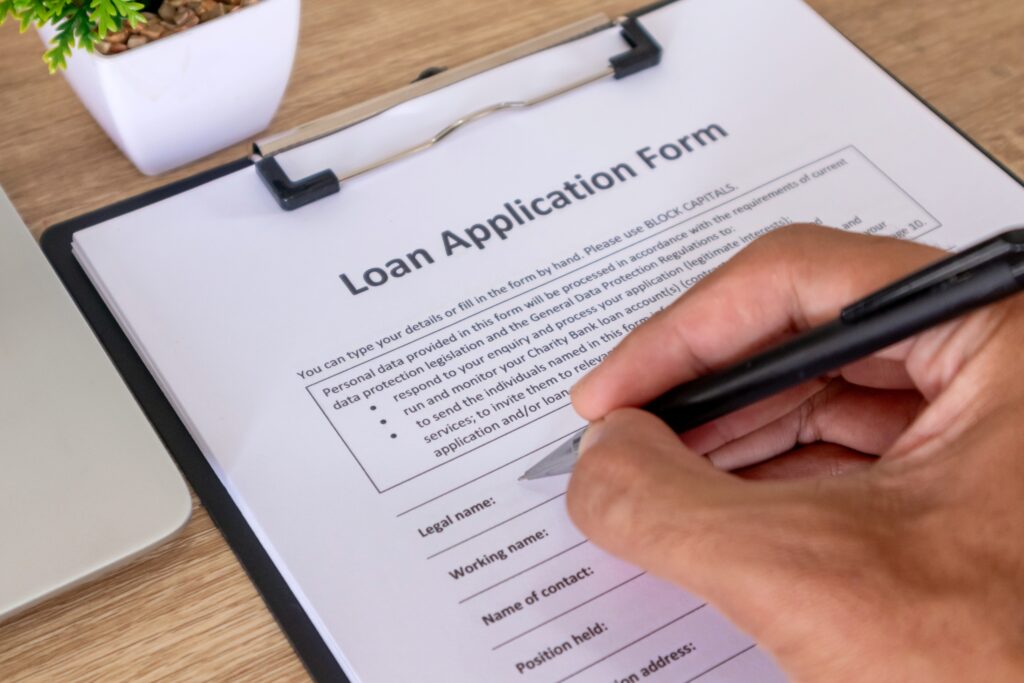 Financial documents, a pen, and a calculator on a desk displaying monthly payment savings when buyers assume FHA loan terms.
